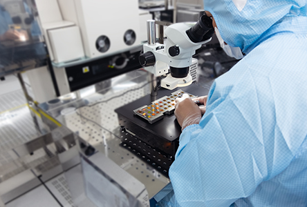 A man looking at the microscope