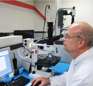 a man working on the desktop in a lab